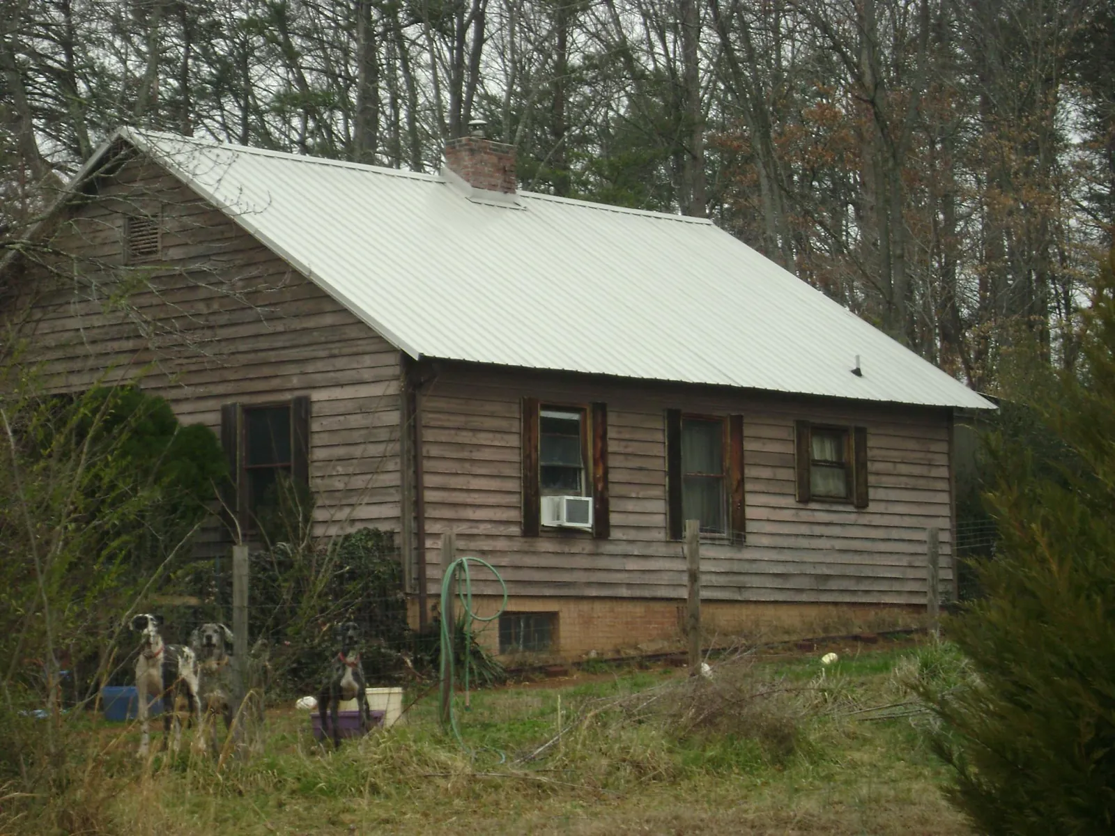 White metal roof on an old wood sided farmhouse, from a Metal Roof Installation job in Mandaree